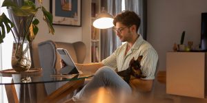Man working remotely from home with pet dog