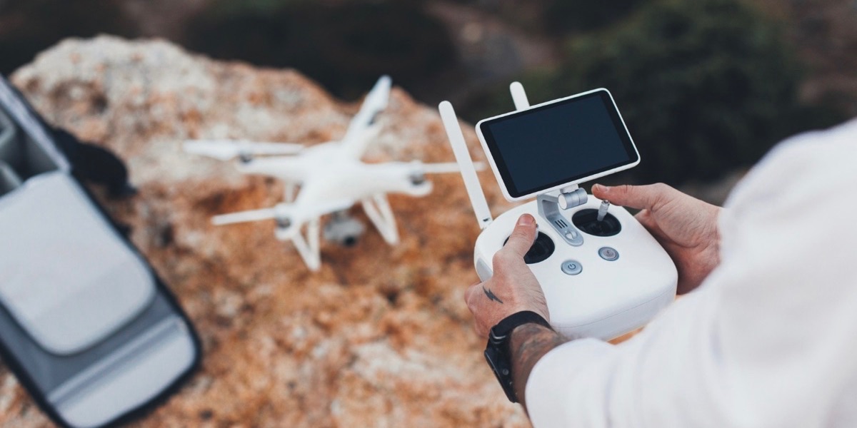 Aerial video creator and photographer prepares drone for flight